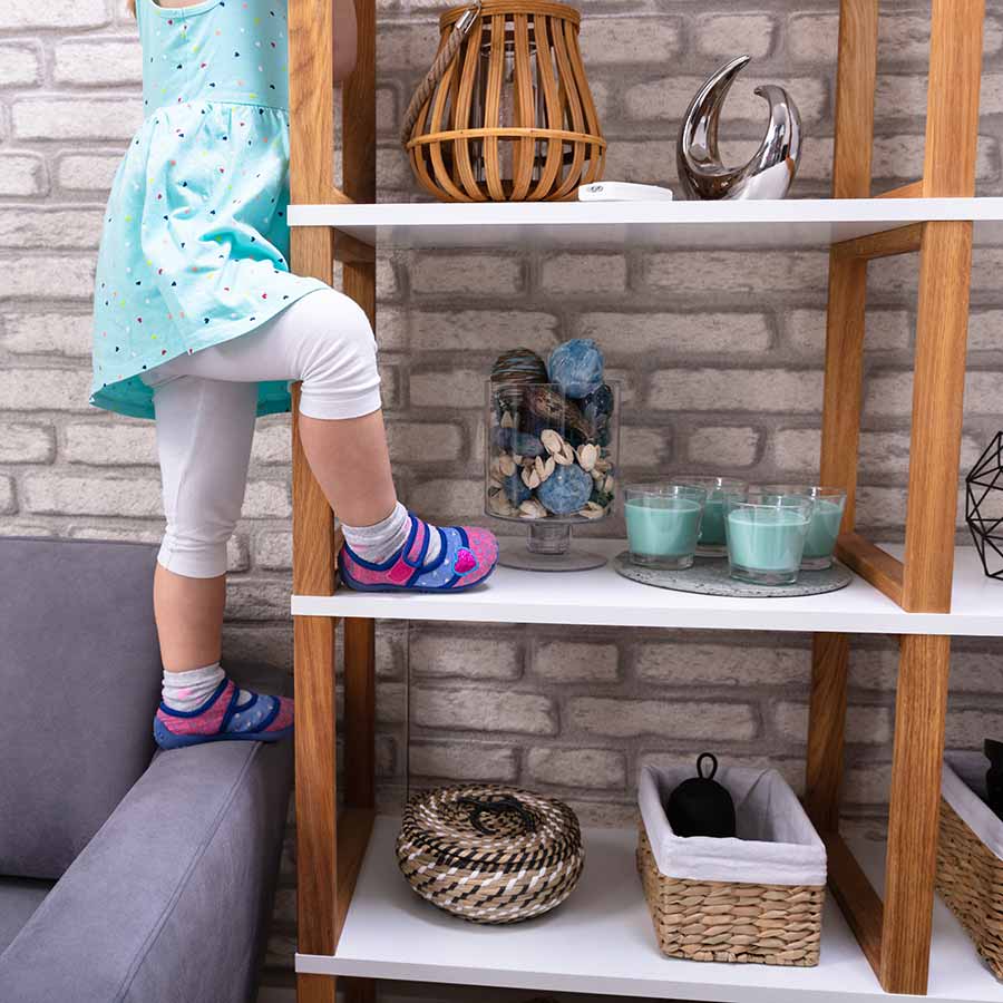 Child Climbing On Bookshelves